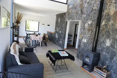 a living room with a couch and a fireplace at Casa Relax Potrero de Garay in Potrero de Garay