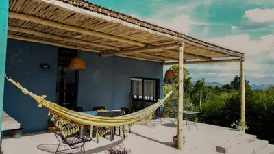 a hammock on the patio of a house at Casa Relax Potrero de Garay in Potrero de Garay