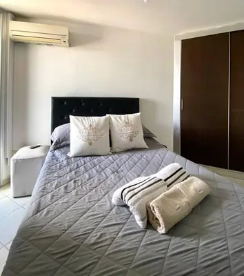 a bed with two pillows and two towels on it at Espejito espejito in Cordoba