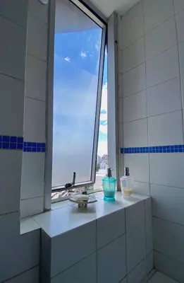 a bathroom with a window with a sink and a sink at Espejito espejito in Cordoba