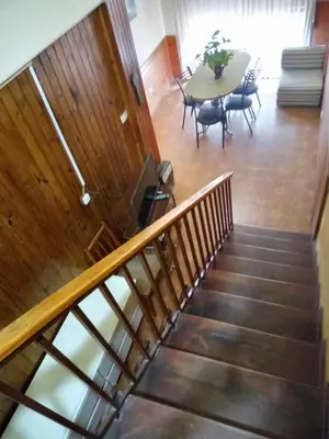 a staircase with a table and chairs and a dining room at HERMINIA in Villa Carlos Paz