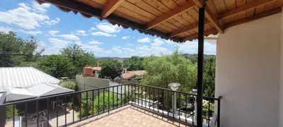 a balcony of a house with a wooden roof at HERMINIA in Villa Carlos Paz