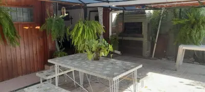 a table with potted plants on a patio at HERMINIA in Villa Carlos Paz