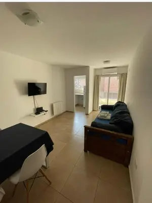 a bedroom with a bed and a flat screen tv at Departamento bien ubicado y cómodo by lofty in Cordoba