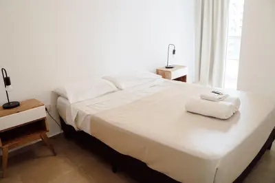 a bedroom with a large bed with towels on it at Departamento bien ubicado y cómodo by lofty in Cordoba