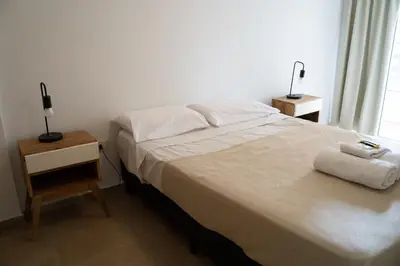 a bedroom with a bed with two towels on it at Departamento bien ubicado y cómodo by lofty in Cordoba