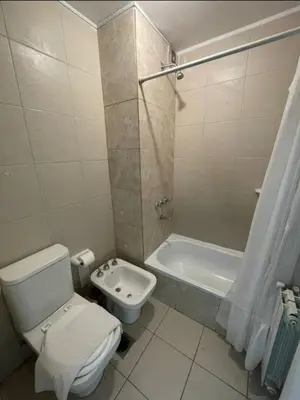 a bathroom with a toilet and a bath tub at Departamento bien ubicado y cómodo by lofty in Cordoba