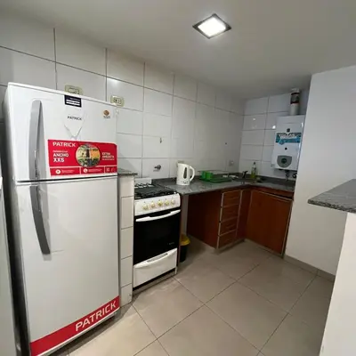 a kitchen with a white refrigerator and a stove at Mairea II bis in Cordoba