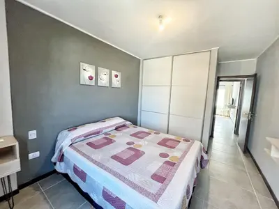a small bedroom with a bed in a room at Berenice III Apartamentos in Villa Carlos Paz