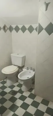 a bathroom with a toilet and a sink at ENTRESIERRAS Y RIO in Santa Rosa de Calamuchita