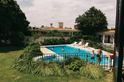a group of people in a swimming pool at ENTRESIERRAS Y RIO in Santa Rosa de Calamuchita