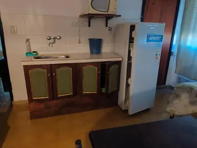 a kitchen with a sink and a refrigerator at ENTRESIERRAS Y RIO in Santa Rosa de Calamuchita