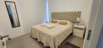 a bedroom with a large bed with two pillows at Gama Top con cochera in Cordoba