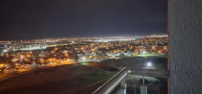 a view of a city at night with lights at Gama Top con cochera in Cordoba