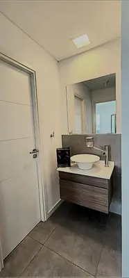 a bathroom with a sink and a mirror at Gama Top con cochera in Cordoba