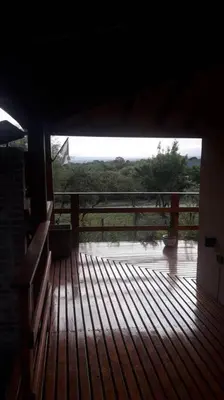 a wooden deck with a view of a bridge at Casa Villa General Belgrano in Villa Ciudad Parque