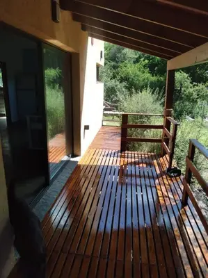 a wooden deck with a bench on a house at Casa Villa General Belgrano in Villa Ciudad Parque