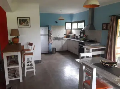 a kitchen with a table and chairs in a room at Casa Villa General Belgrano in Villa Ciudad Parque
