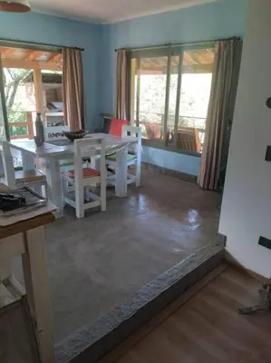a living room with a white table and chairs at Casa Villa General Belgrano in Villa Ciudad Parque