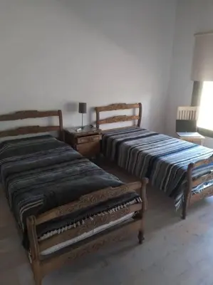 two beds sitting next to each other in a room at Casa Villa General Belgrano in Villa Ciudad Parque