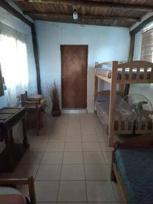 a room with two bunk beds and a door at Casa de montaña in Bialet Massé