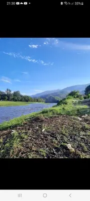 a view of a body of water with mountains in the background at Casa de montaña in Bialet Massé