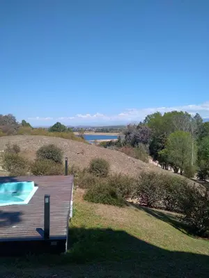 a house with a swimming pool on top of a hill at Condominio Monte Molinos - dpto en Nautico, 2 dormitorios y vista al lago in Villa Ciudad de America