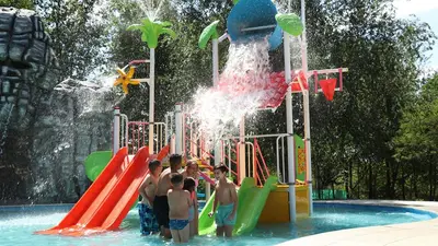 a group of young boys standing in a water park at Condominio Monte Molinos - dpto en Nautico, 2 dormitorios y vista al lago in Villa Ciudad de America