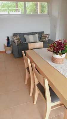 a living room with a table and a couch at Condominio Monte Molinos - dpto en Nautico, 2 dormitorios y vista al lago in Villa Ciudad de America