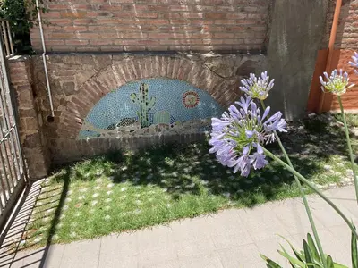 a mosaic mural of a cactus on a brick wall at Los Zorzales in Villa Carlos Paz