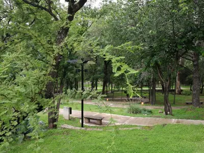 a park with benches and a street light and trees at Los Zorzales in Villa Carlos Paz