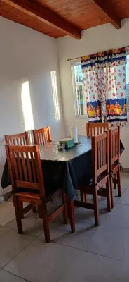 a dining room with a table and two chairs at El Molle in Estancia Vieja