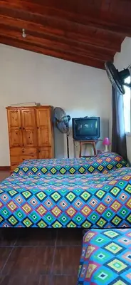 a bedroom with a bed and a television in it at El Molle in Estancia Vieja