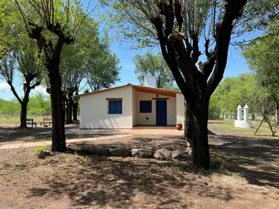 a small white building with trees in front of it at Casa Azul in Santa Rosa de Calamuchita