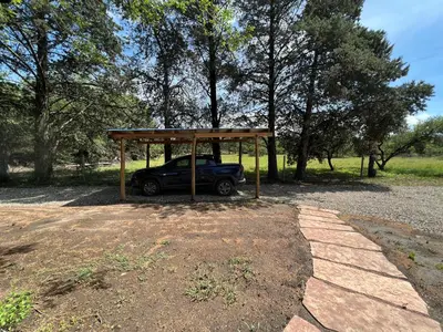 a car parked under a canopy in a park at Casa Azul in Santa Rosa de Calamuchita