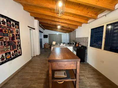 a kitchen with a island in the middle of a room at Casa Azul in Santa Rosa de Calamuchita