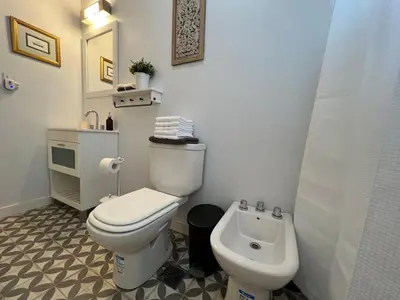a bathroom with a white toilet and a bidet at Casa Azul in Santa Rosa de Calamuchita