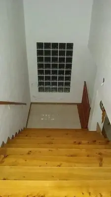an empty room with wooden stairs and a vent at RESIDENCIA EL TALA in Cordoba