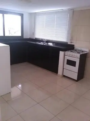 a kitchen with a stove and a sink in it at RESIDENCIA EL TALA in Cordoba