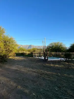 a dirt field with a fence and mountains in the background at Casa Grande Reservas por privado in San Javier