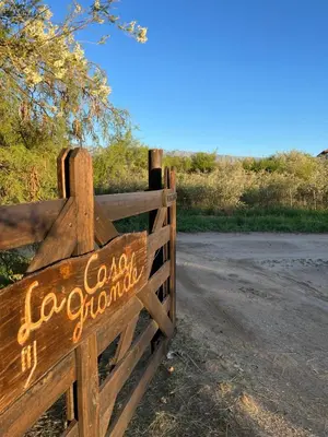 a wooden gate with a sign on a road at Casa Grande Reservas por privado in San Javier