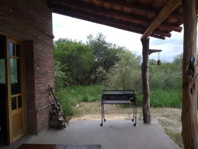 a bench sitting outside of a brick building at Casa Grande Reservas por privado in San Javier
