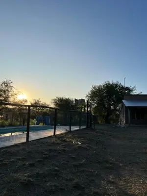 a fence next to a pool with the sunset in the background at Casa Grande Reservas por privado in San Javier