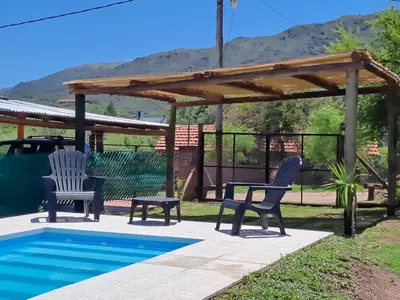 two chairs and a pergola next to a swimming pool at CABAÑA LA HERRADURA 14 in San Roque