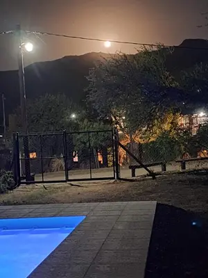 a park at night with a playground at CABAÑA LA HERRADURA 14 in San Roque