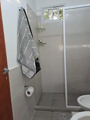 a bathroom with a shower and a toilet at CABAÑA LA HERRADURA 14 in San Roque