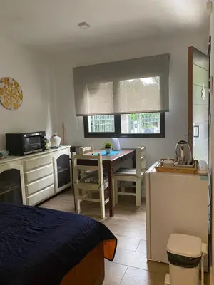 a room with a kitchen and a table with a sink at Apartamento Plaza Las Vertientes in Villa Carlos Paz