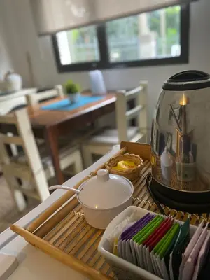 a table with a tea pot and a bowl on it at Apartamento Plaza Las Vertientes in Villa Carlos Paz