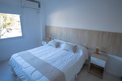 a bedroom with a white bed and a window at Santa Cecilia Boutique in Villa Carlos Paz