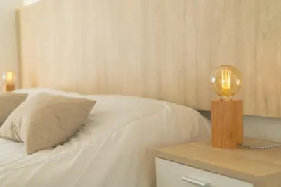a bed with a nightstand with a lamp on it at Santa Cecilia Boutique in Villa Carlos Paz